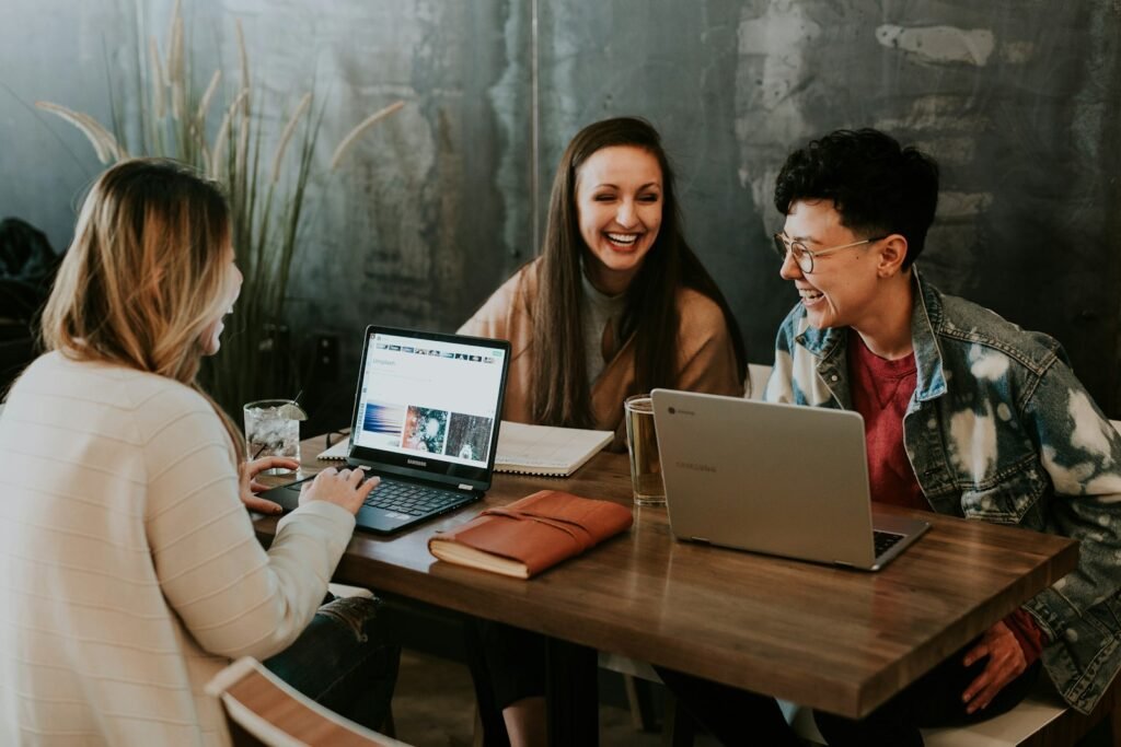 Business team reviewing a company website on laptops