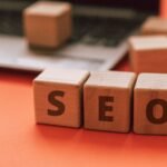 Wooden blocks spelling SEO resting on a laptop keyboard