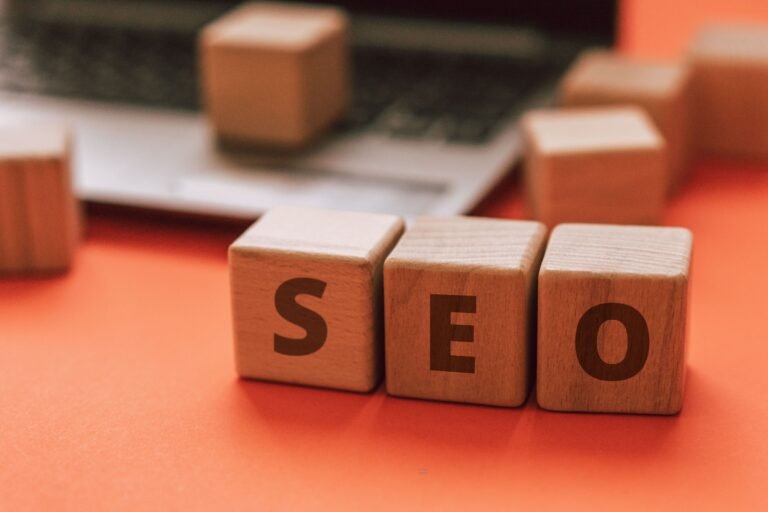 Wooden blocks spelling SEO resting on a laptop keyboard